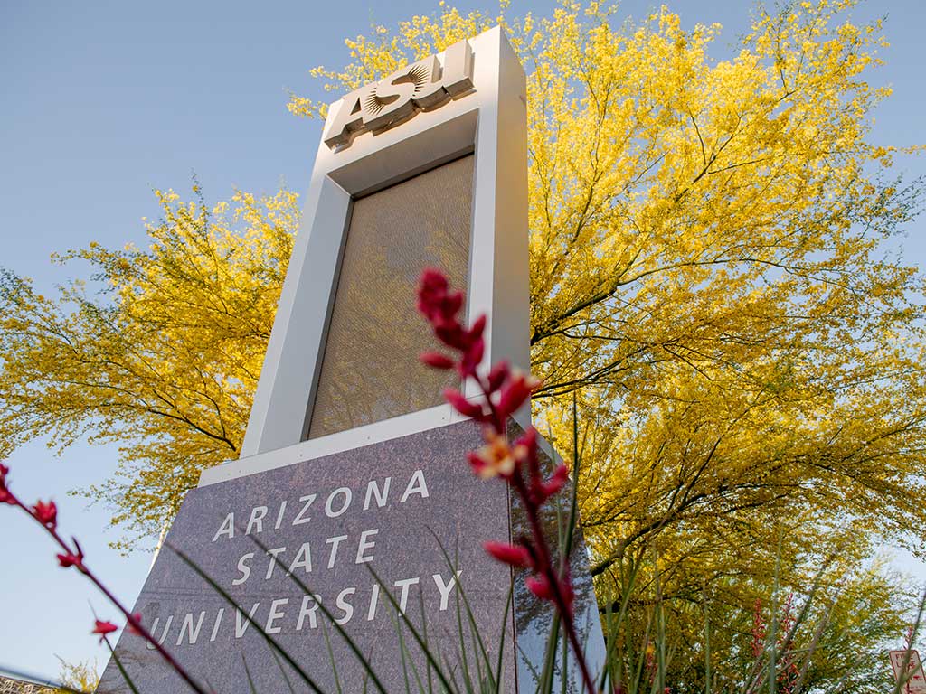 ASU sign on campus with gold leaves and blue sky in the background